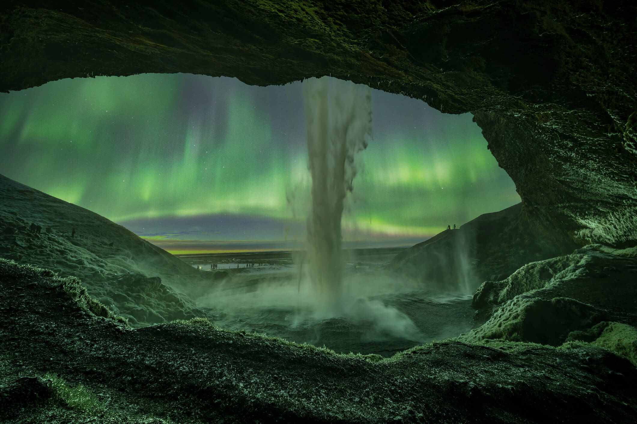 Aurora borealis above Seljalandsfoss waterfall in South Iceland near Harmony Seljalandsfoss