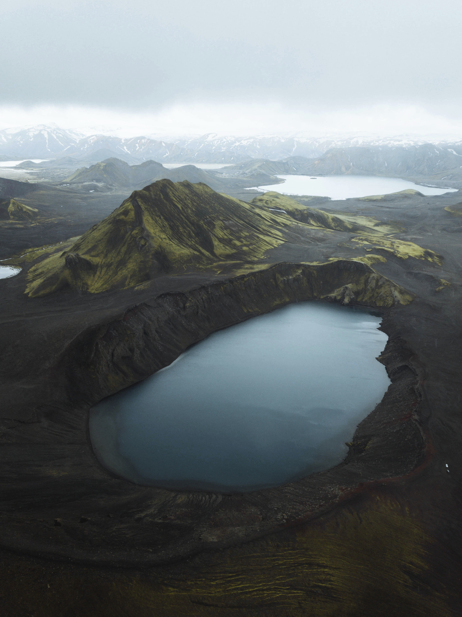 Bláhylur blue volcanic crater lake near Landmannalaugar in Iceland’s Highlands, surrounded by red mountains and silence.