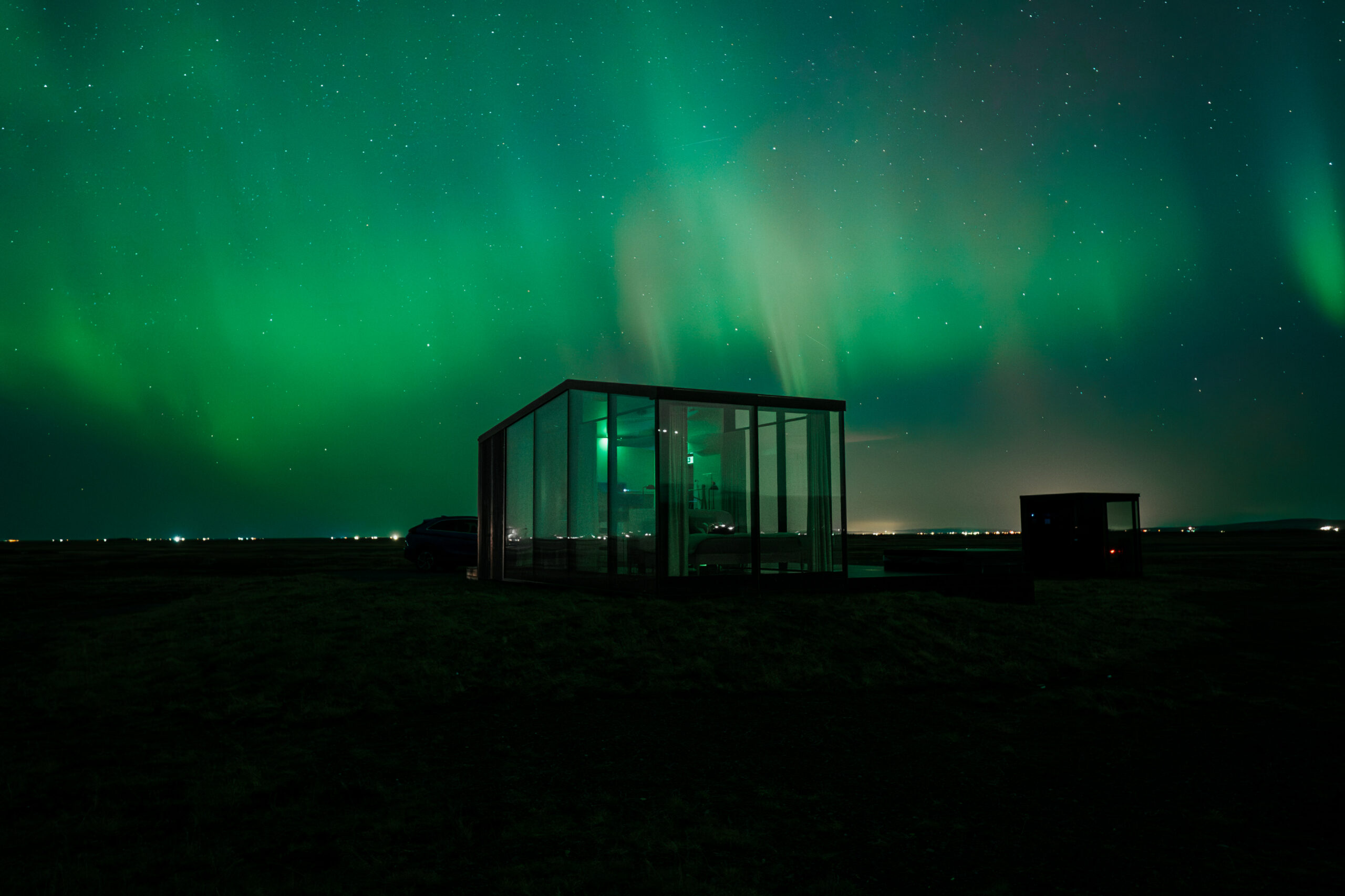 Northern Lights over Harmony Seljalandsfoss Glass Lodge in South Iceland with panoramic aurora view