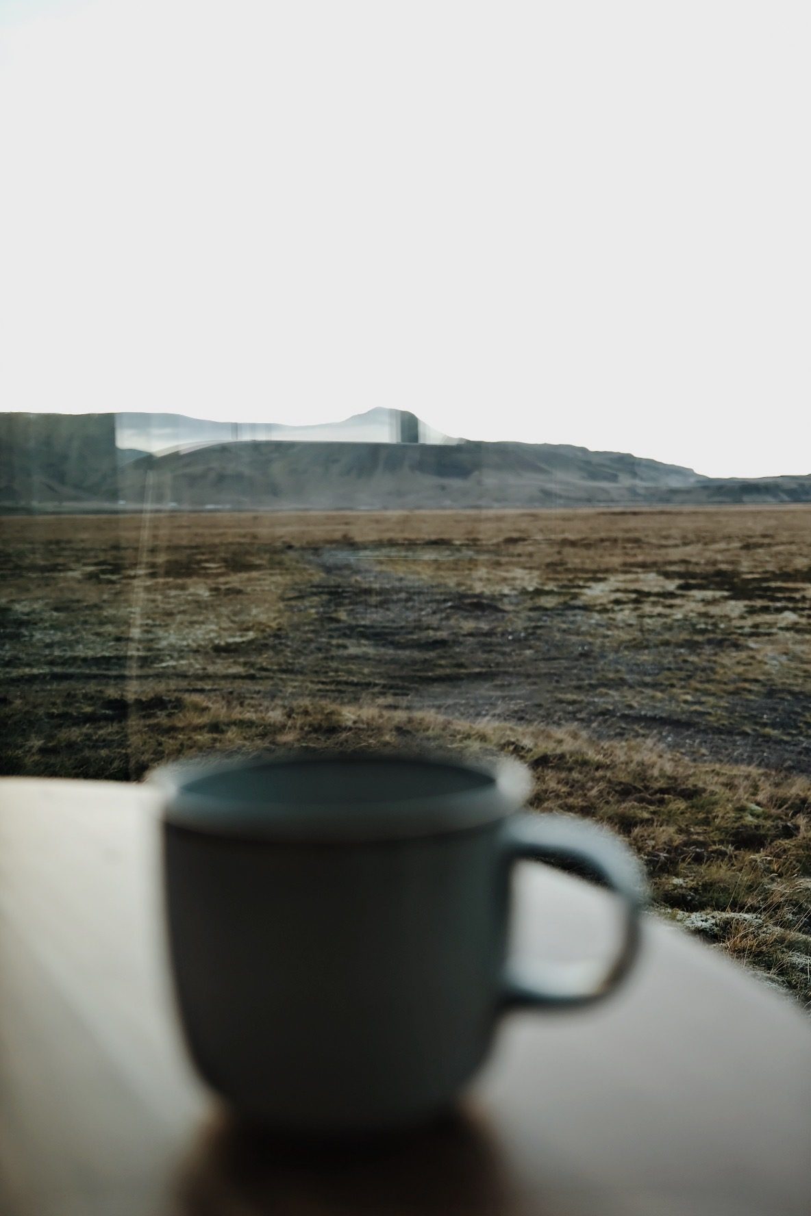 Morning coffee by the window facing the Icelandic landscape at Harmony Seljalandsfoss