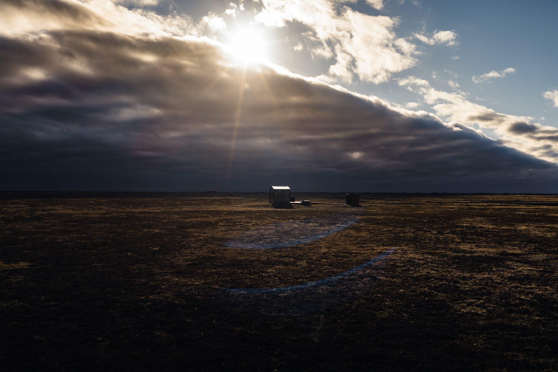 Sunlight breaking over the South Iceland plain on the path to Harmony lodge
