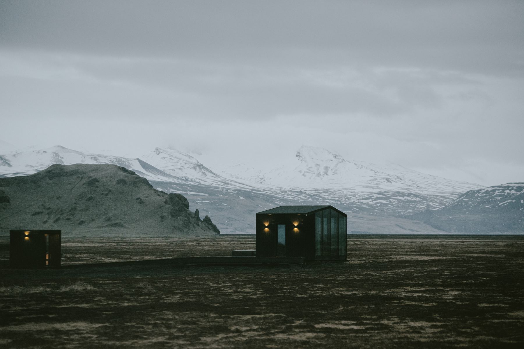Glass roof lodge at Harmony Seljalandsfoss alone on the South Iceland tundra beneath snow covered mountains