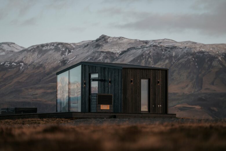 Harmony Seljalandsfoss glass lodge beneath the first autumn snow on the Eyjafjöll mountains in South Iceland