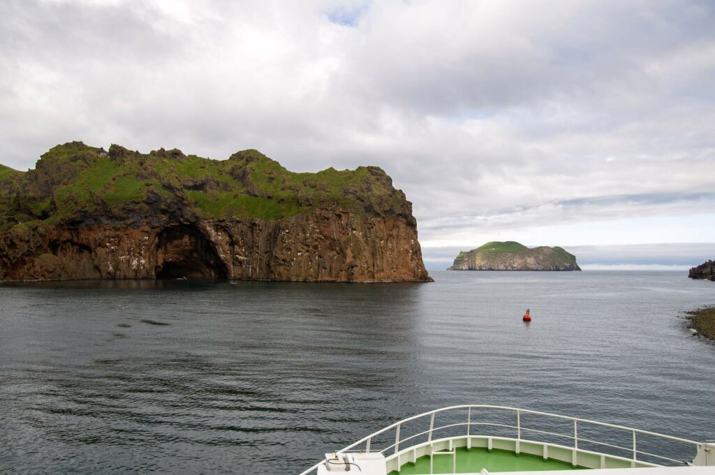 View from the ferry bow approaching the cliffs of Heimaey, Westman Islands, Iceland